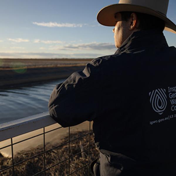 Field officer looking at an irrigation channel.